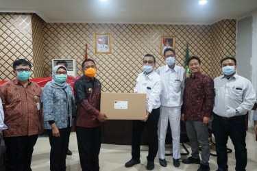 Bupati Bekasi, Eka Supria Atmaja saat menerima secara simbolis bantuan APD berupa surgical gown dari PT. Hogy Indonesia, Jum’at (03/04) | Foto: Humas Pemkab Bekasi