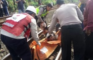 Petugas saat mengevakuasi jenazah korban yang tertabrak kereta api Fajar Utama di perlintasan KA di Kp. Mekarsari Desa Tambun Kecamatan Tambun Selatan, Selasa (16/01) pagi.