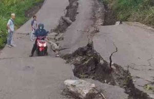 Sebelum ditutup, seorang pengendara motor nekat menerobos ruas jalan yang amblas di Jalan Raya Kodam.