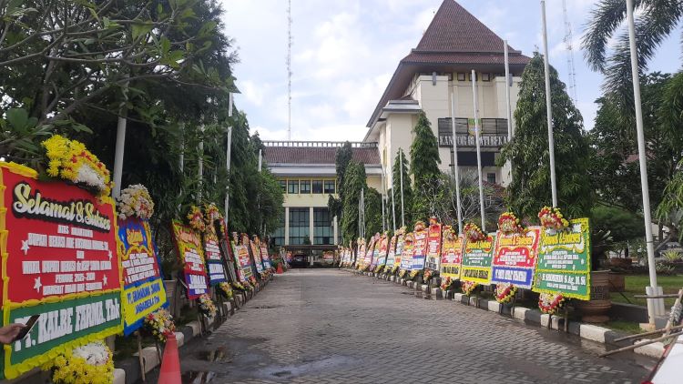 Menjelang hari pelantikan, suasana di Gedung Bupati Bekasi, Komplek Perkantoran Pemkab Bekasi, sudah terasa meriah. Puluhan papan karangan bunga ucapan selamat berjajar rapi di depan gedung tersebut sejak Selasa siang (18/02) kemarin. Ucapan-ucapan ini datang dari berbagai pihak, mulai dari perangkat daerah, organisasi masyarakat, lembaga swasta, hingga BUMD dan relasi kerja